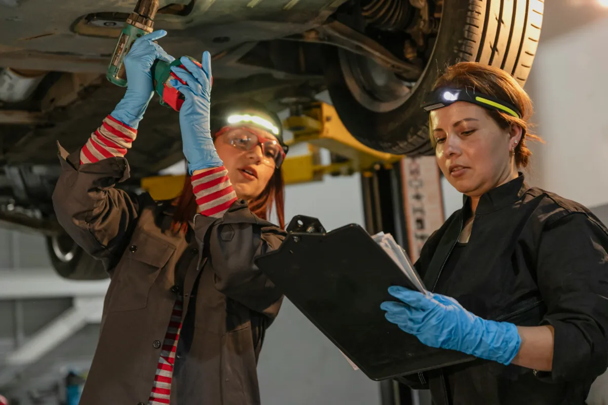 Professional technicians conducting thorough pre-purchase vehicle inspection