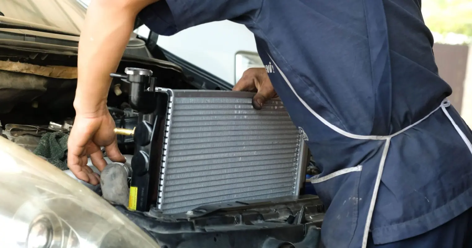 Professional technician working on radiator and cooling system at API Auto Repair in Elkridge, MD