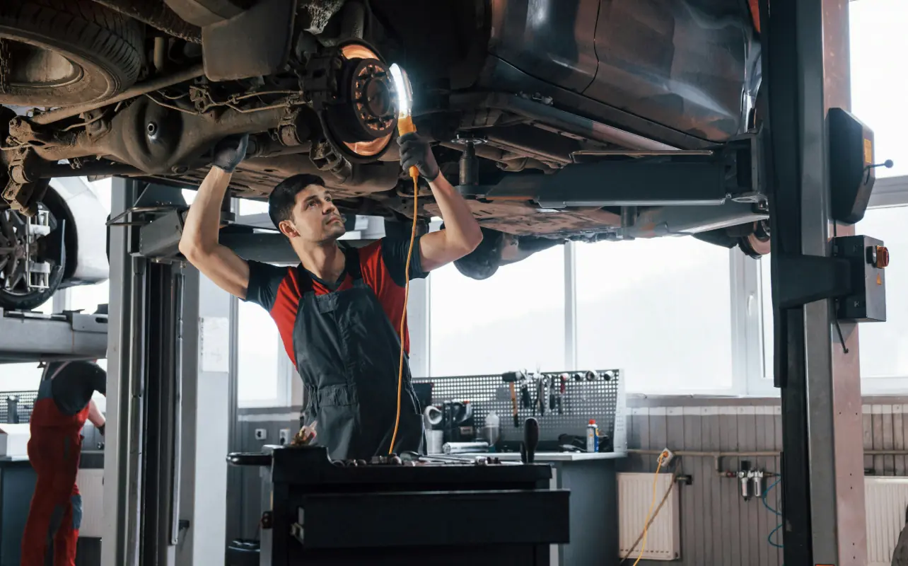 Professional technician performing suspension and steering repair work at API Auto Repair in Elkridge, MD